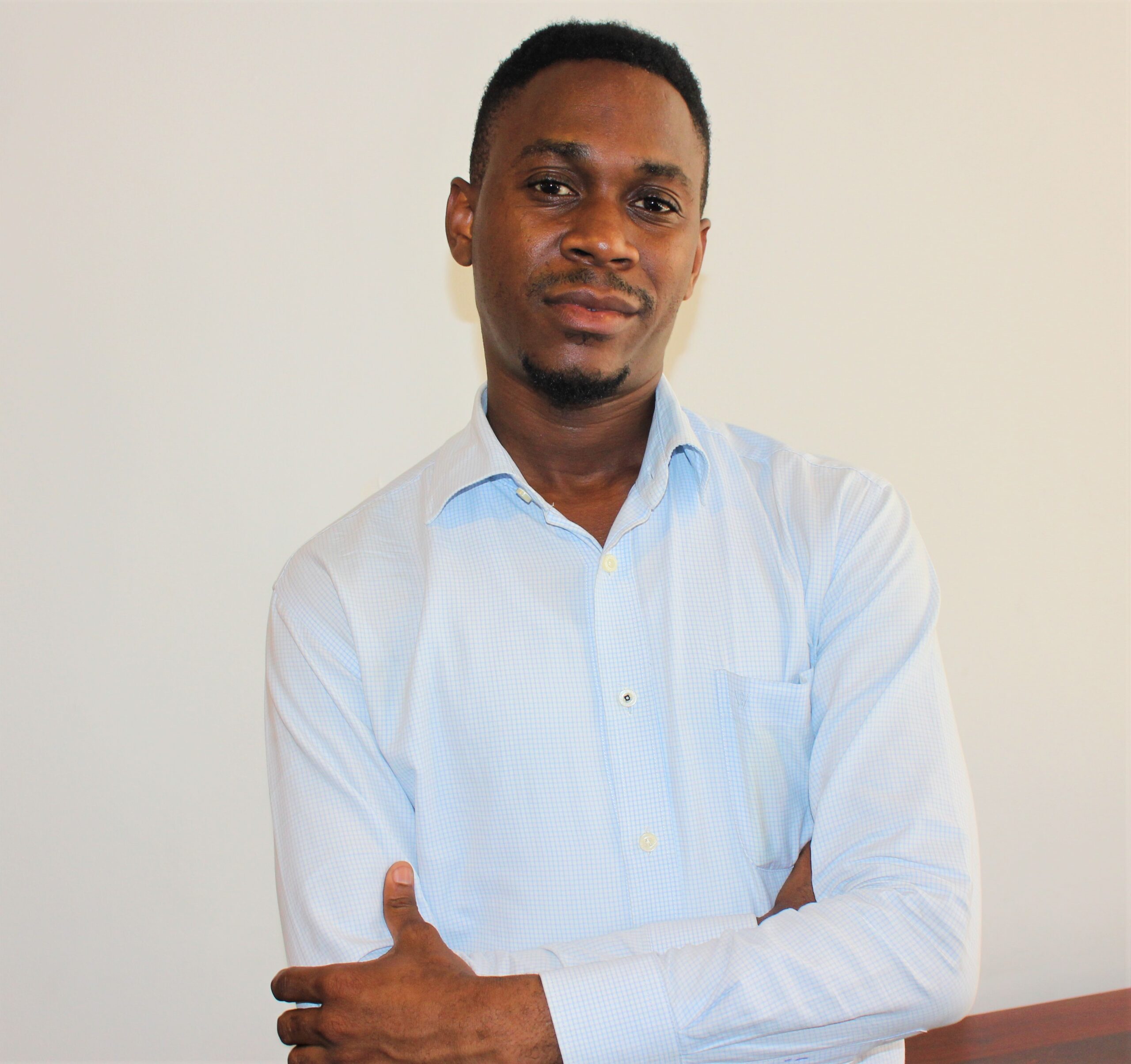 A young Tanzanian man smiling at the camera