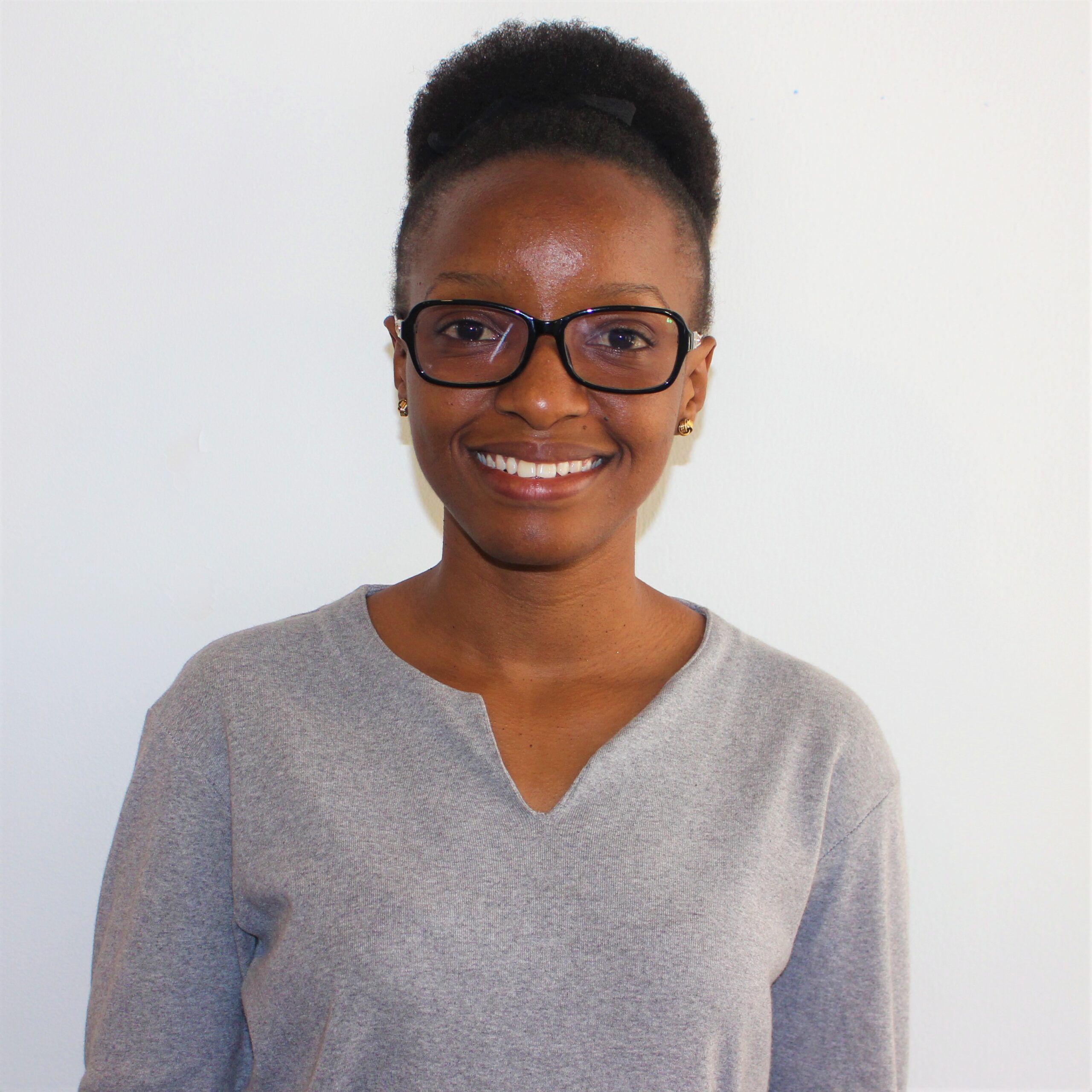 A young Tanzanian woman smiling at the camera