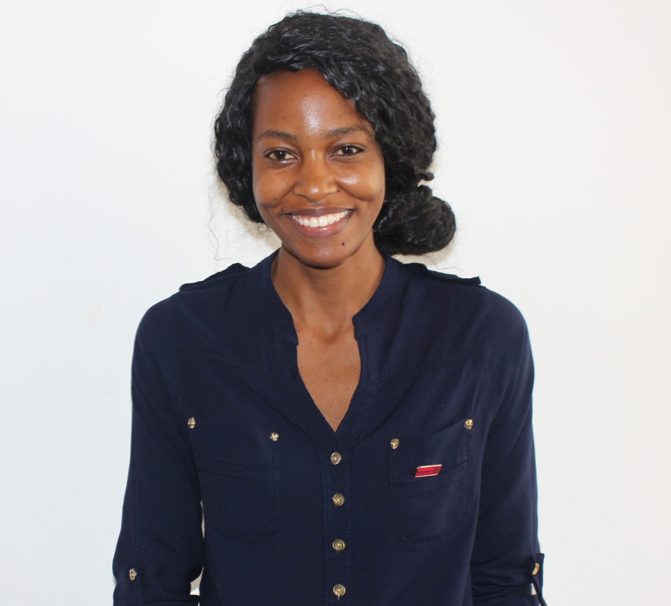 A young Tanzanian woman smiling at the camera