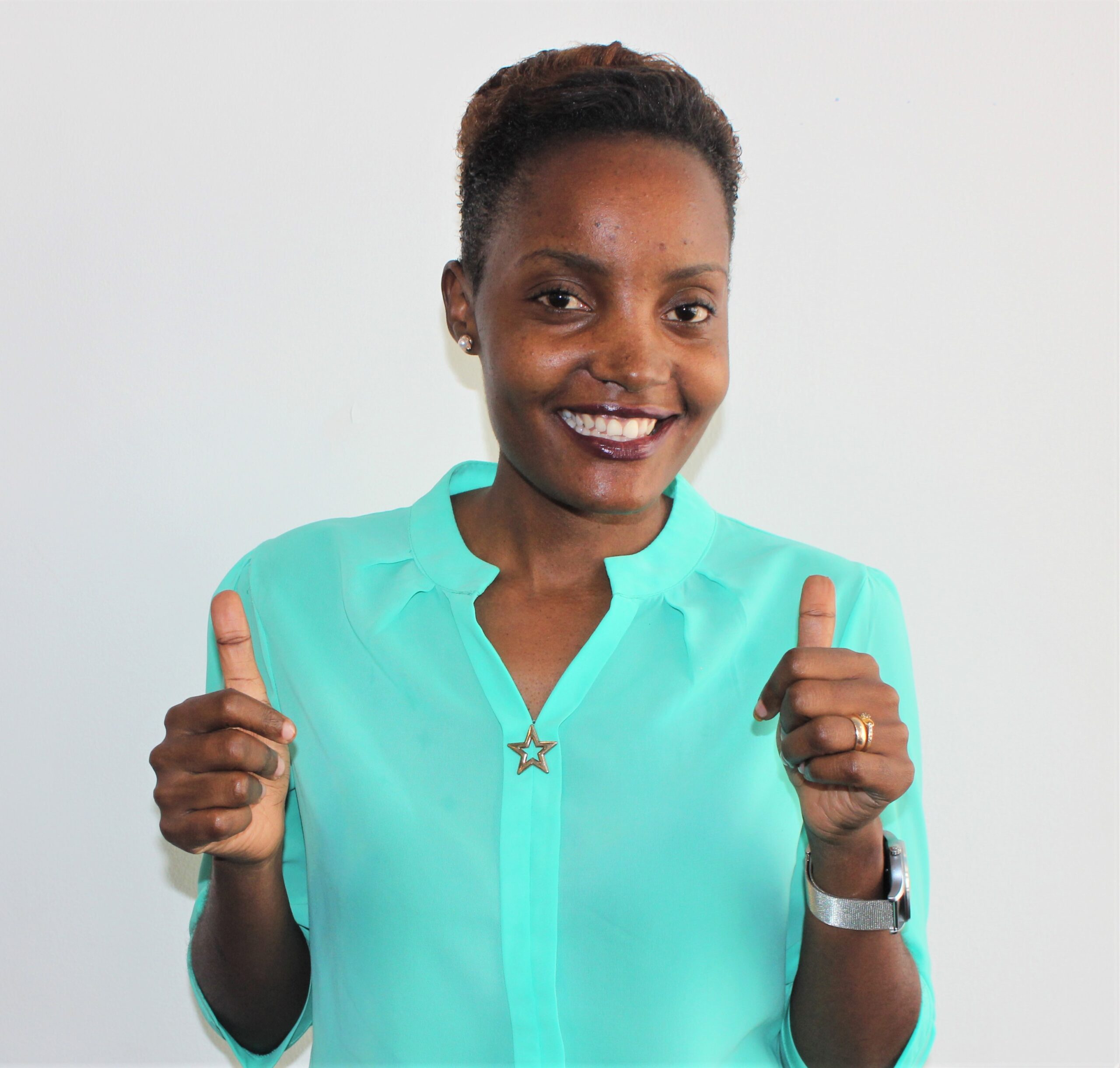 A young Tanzanian woman smiling at the camera