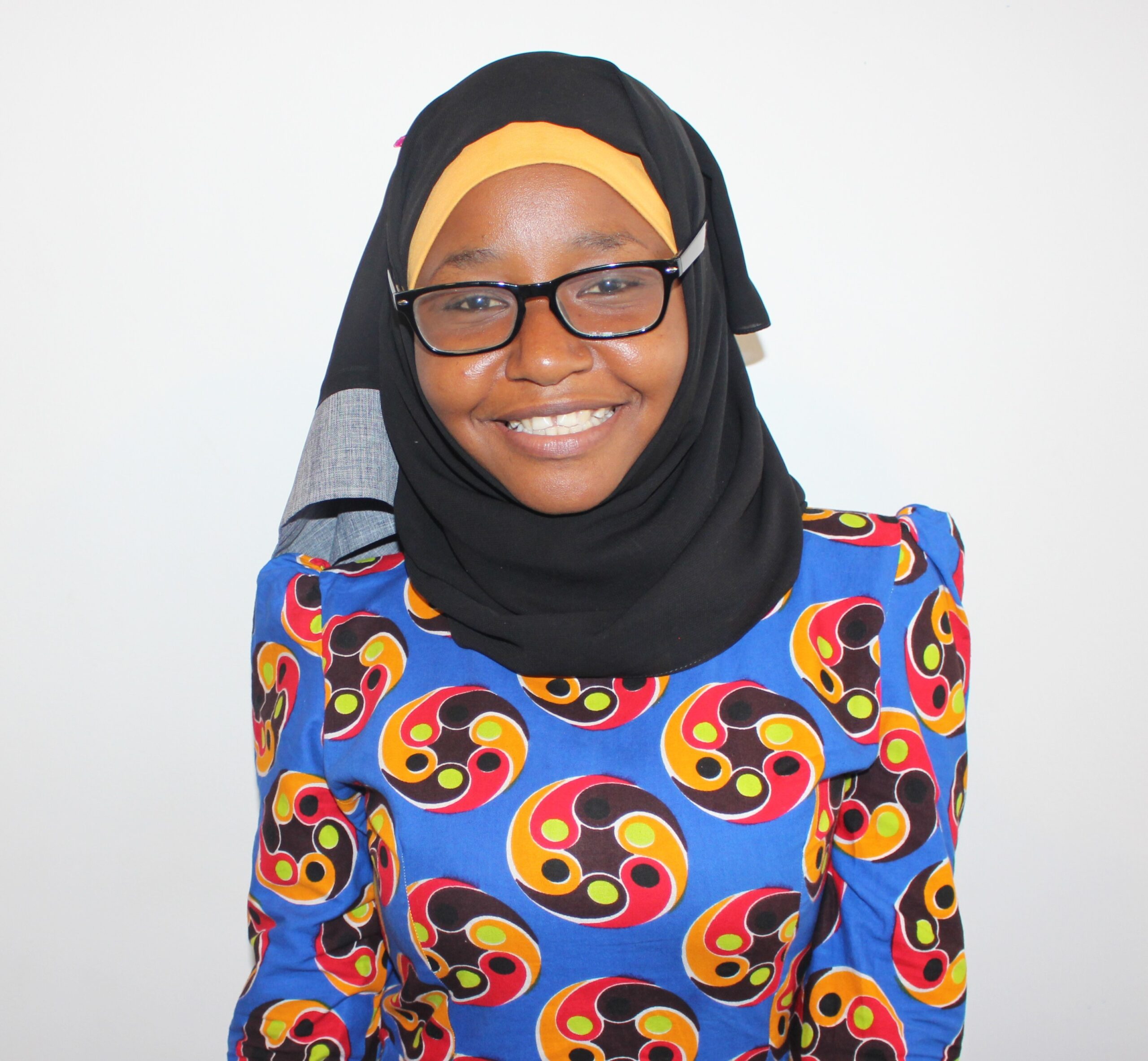 A young Tanzanian woman smiling at the camera