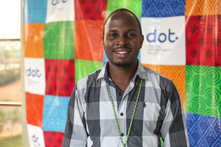 A young man smiles into the camera.